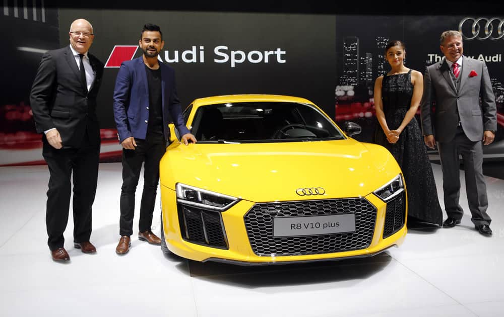 Indian cricketer Virat Kohli, second left and Bollywood actor Alia Bhatt during the launch of Audi R8 V10 plus at the Auto Expo in Greater Noida, near New Delhi.