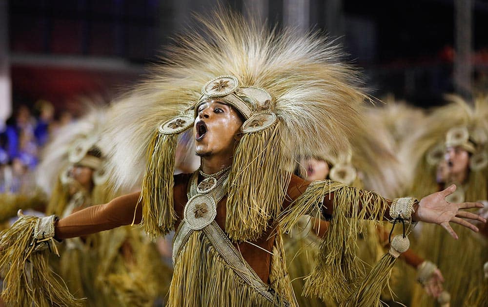 A dancer from the Perola Negra samba school perform during a carnival parade in Sao Paulo, Brazil.