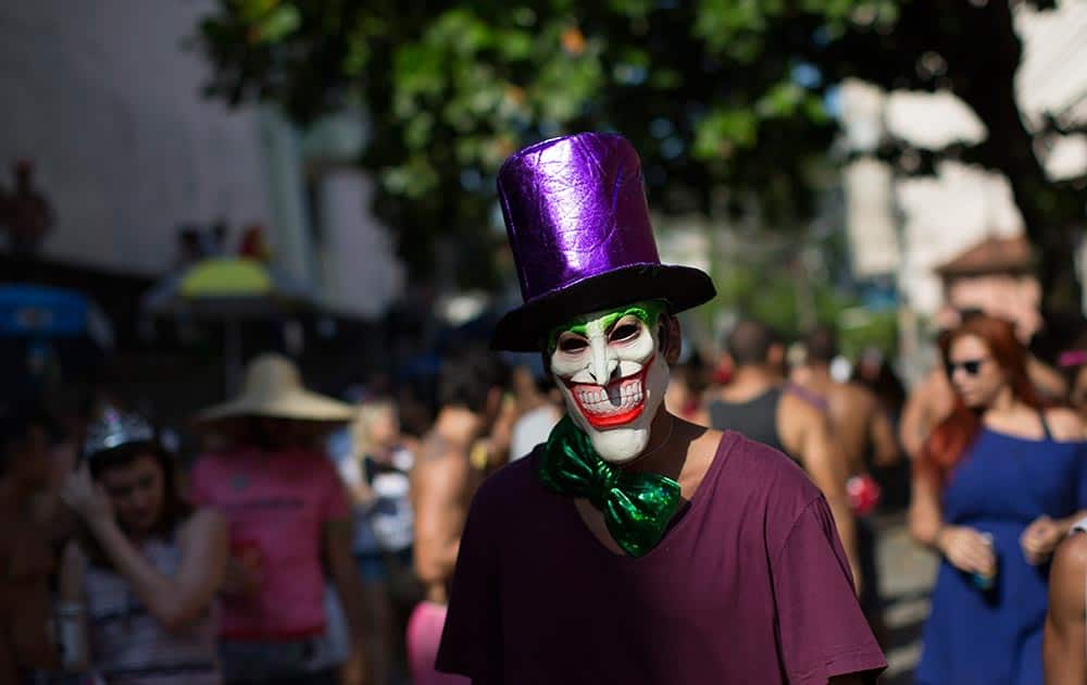 A reveler wearing a mask depicting the 'The Joker' comic character, attends the 'Carmelitas' block party during Carnival celebrations in Rio de Janeiro, Brazil.