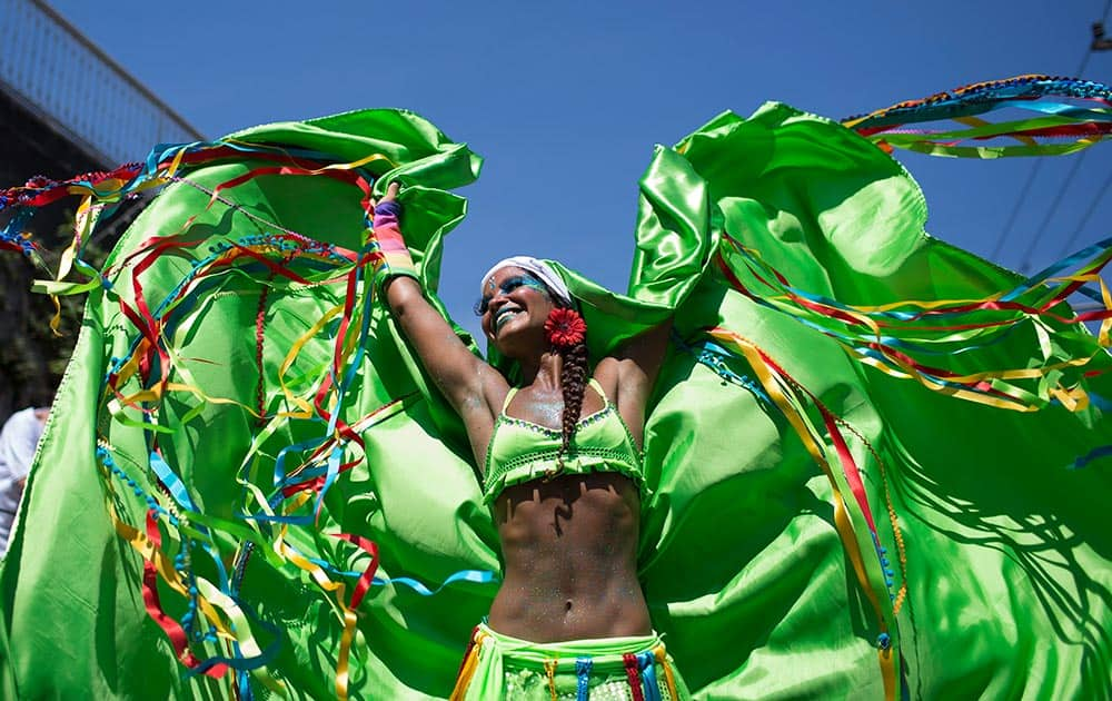 A reveler performs at the 'Carmelitas' block party during Carnival celebrations in Rio de Janeiro, Brazil.