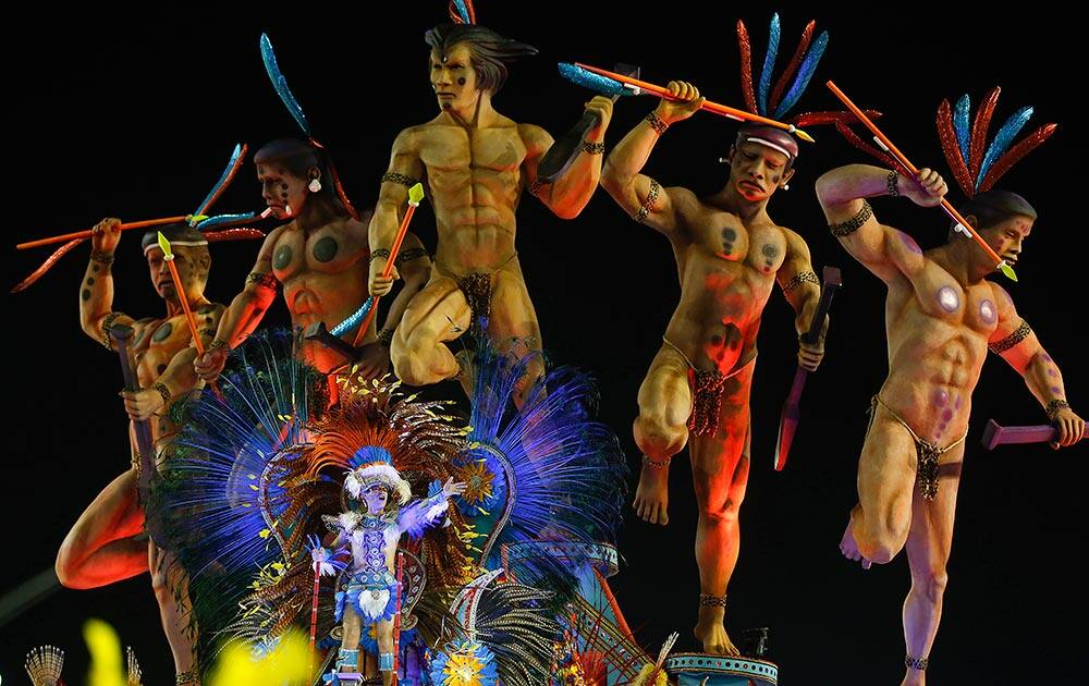 A dancer from the Perola Negra samba school performs on a float during a carnival parade in Sao Paulo, Brazil.