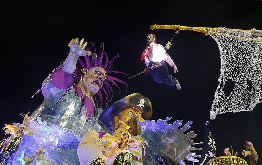 Dancers from the Unidos da Vila Maria samba school perform on a float during a carnival parade in Sao Paulo.