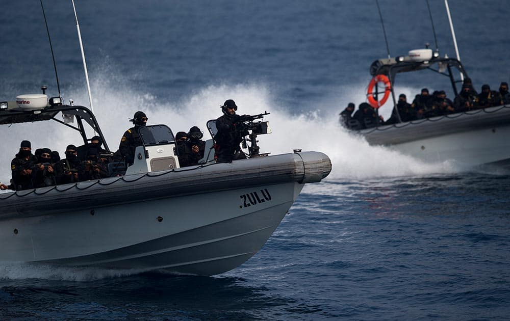 Indian naval commandos show their prowess during the final rehearsal of International Fleet review in Vishakapatnam.