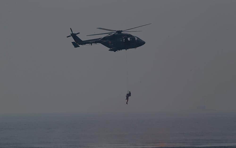 An Indian navy helicopter shows a rescue operation during the final rehearsal of International Fleet review in Vishakapatnam.