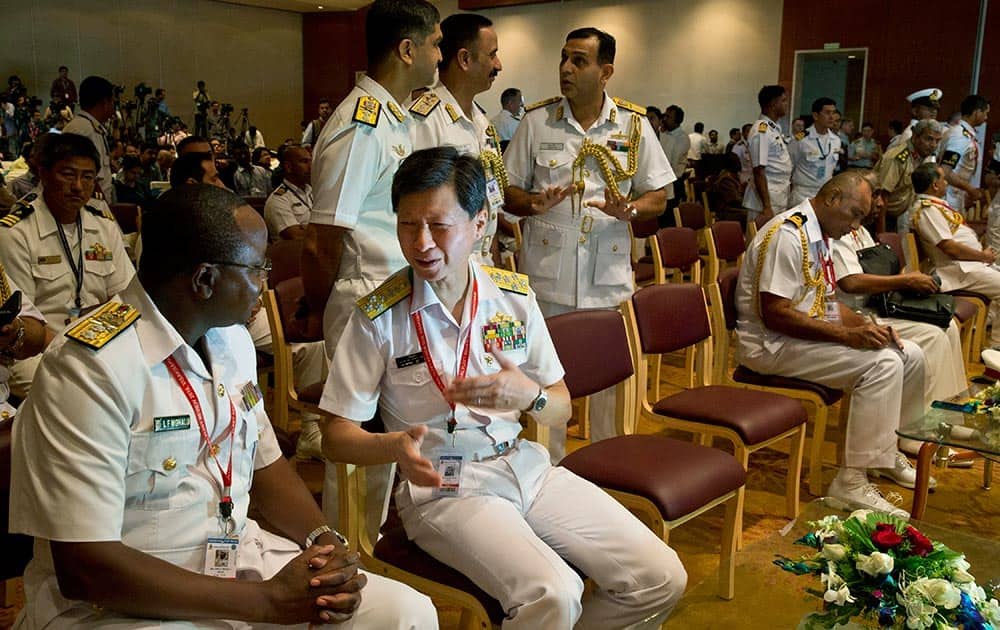 Chief of Staff of Japan Maritime Self-Defense Force Tomohisa Takei, second left, meets other foreign delegates during the International Fleet Review in Vishakapatnam.