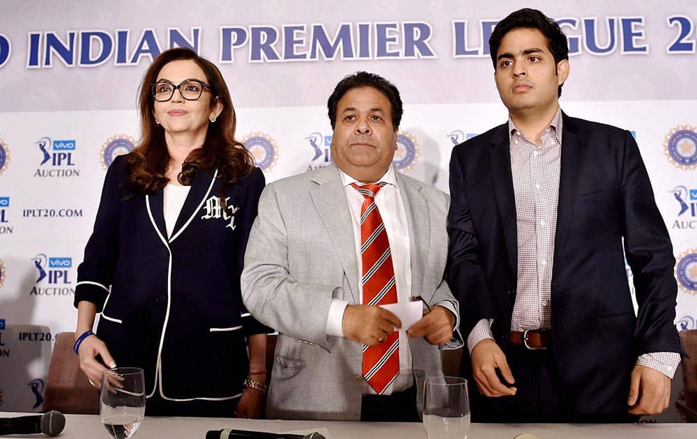IPL chairman Rajeev Shukla with Mumbai Indians owner Neeta Ambani and her son Akash at a press conference during the IPL players auction in Bengaluru.