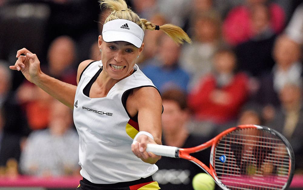 ngelique Kerber of Germany returns a ball to Timea Bacsinszky of Switzerland during their Fed Cup World Group first round tennis match between Germany and Switzerland in Leipzig, Germany.