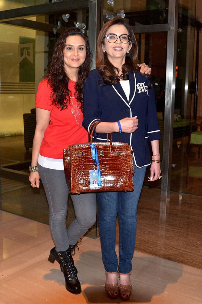 Mumbai Indians owner Neeta Ambani and Kings XI Punjab co-owner Priety Zinta arrive at a press conference during the IPL players auction in Bengaluru.