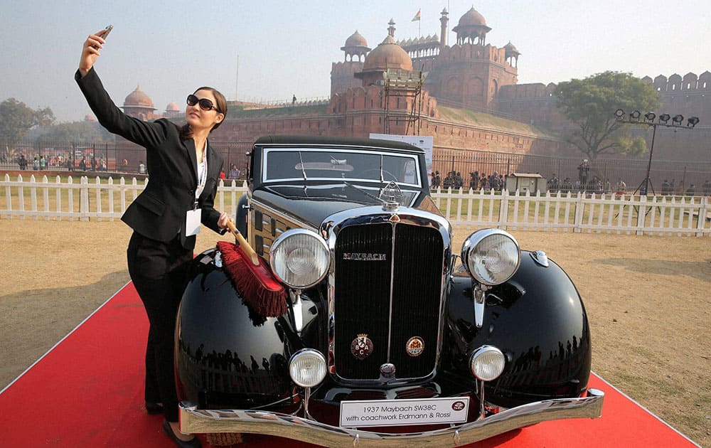 A lady taking selfie with a vintage car during 21 Gun Salute Vintage Car Show at Red Fort in New Delhi.