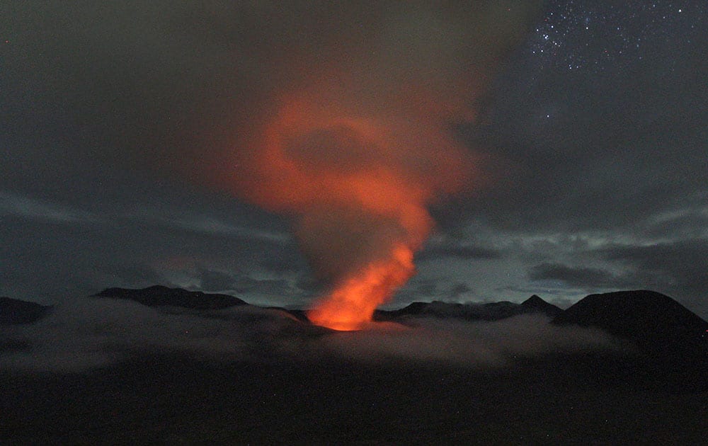 Mount Bromo spews volcanic materials into the air as seen from Ngadisari, East Java, Indonesia.