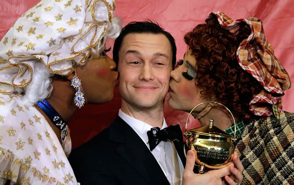 Actor Joseph Gordon-Levitt is kissed by two actors in drag after being awarded the pudding pot as Harvard University's Hasty Pudding Theatricals Man of the Year in Cambridge, Mass.