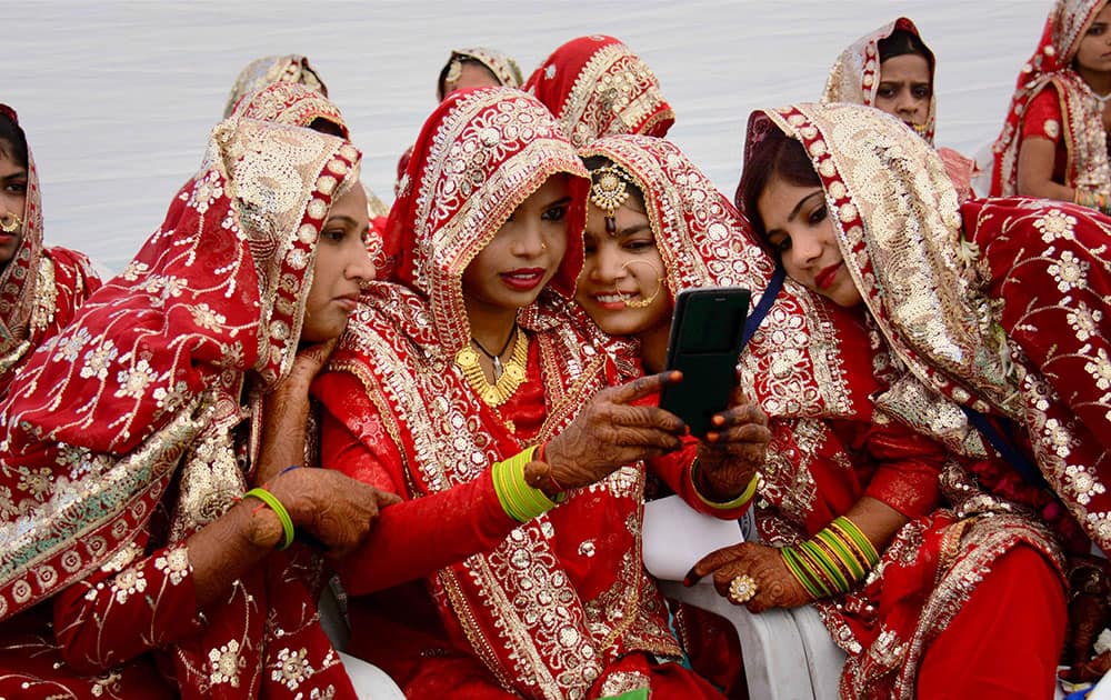 Brides taking selfie during mass marriage event in Ahmadabad.
