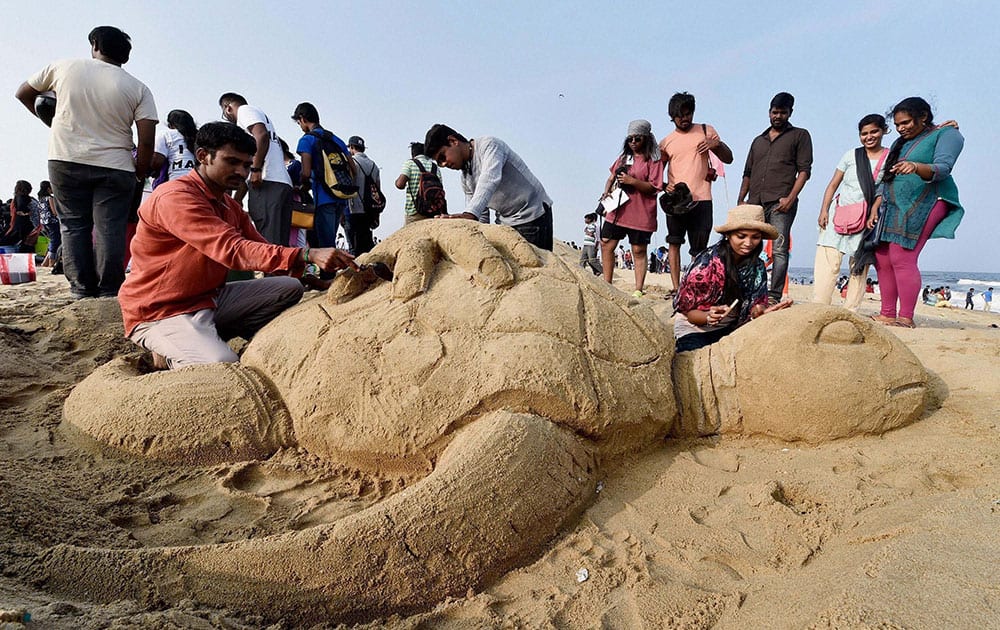 College students and volunteers make sand sculpture of turtles at Marina Beach as part of a Save a Turtle campaign at marina beach in Chennai.