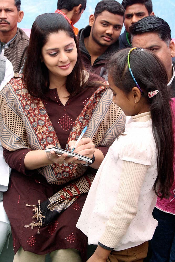 Film actress and politician Nagma gives autograph to her fan during a cleanliness drive in Meerut.