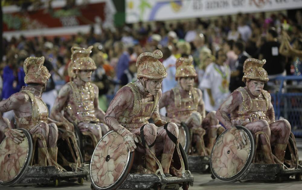 Performers from Uniao da Ilha samba school parade in wheelchairs during Carnival celebrations at the Sambadrome in Rio de Janeiro, Brazil.