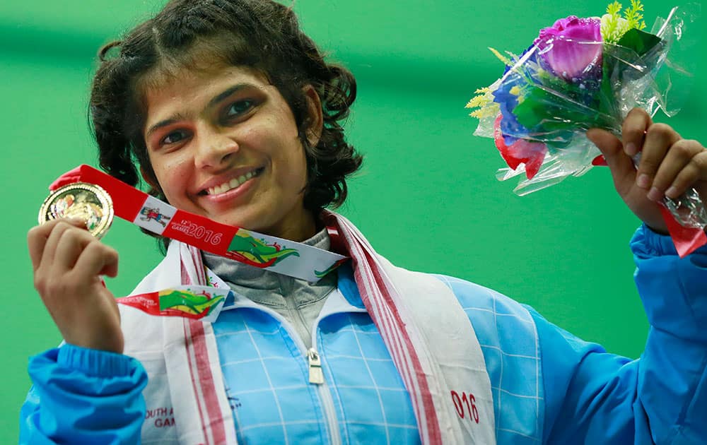 India's Shilpi Sheoran displays the gold medal during the 63 kg women wrestling medal ceremony in the South Asian Games in Gauhati, India.