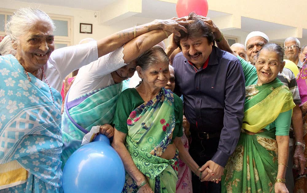 Ghazal maestro Pankaj Udhas being blessed by Senior citizens at Sir J. J. Dharmashala, in Mumbai.