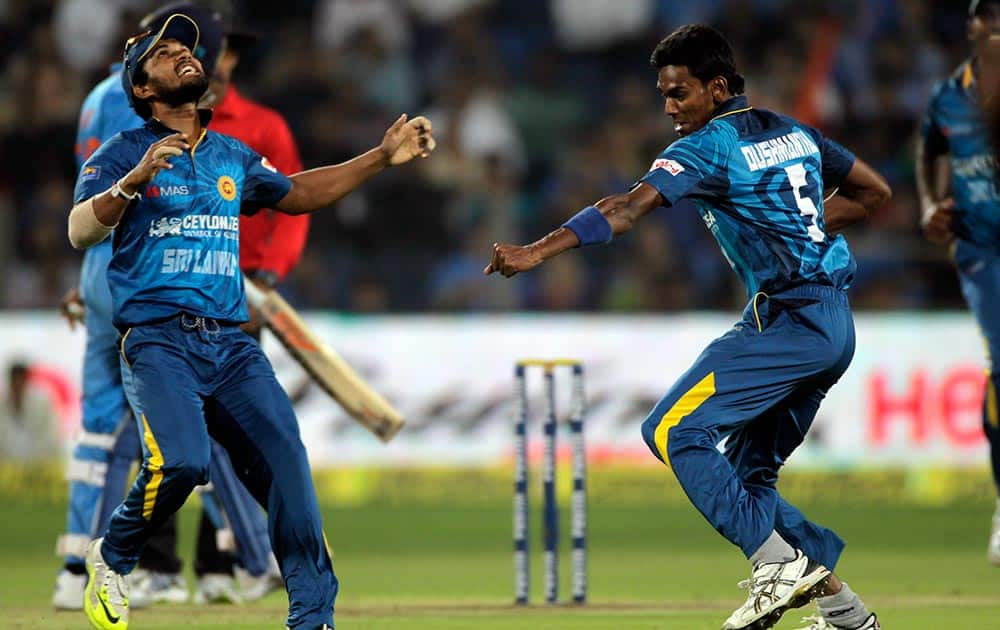 Sri Lanka cricket player Dushmantha Chameera, left celebrates during the first T20 match between India and Sri Lanka in Pune.