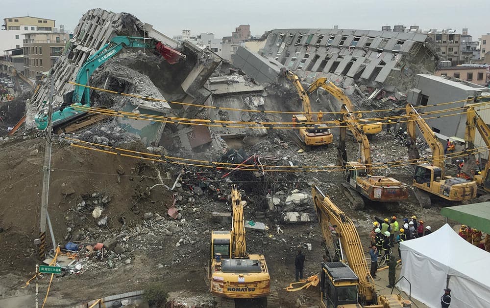 Rescue workers using excavators continue to search the rubble of a collapsed building complex in Tainan, Taiwan.