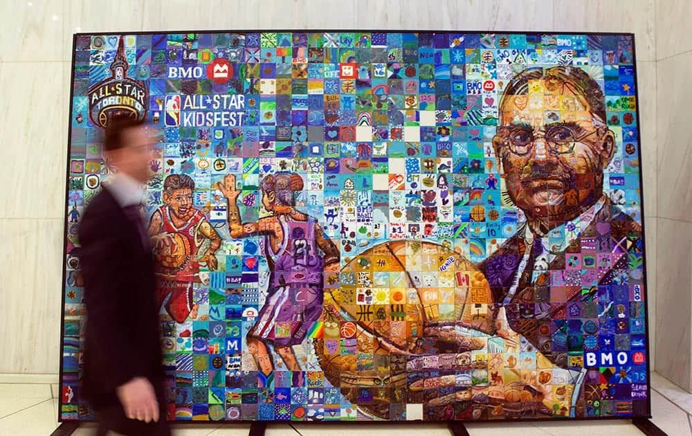 A BMO employee walks past a mural created by Alberta artist Lewis Lavoie, at BMO's Toronto offices.