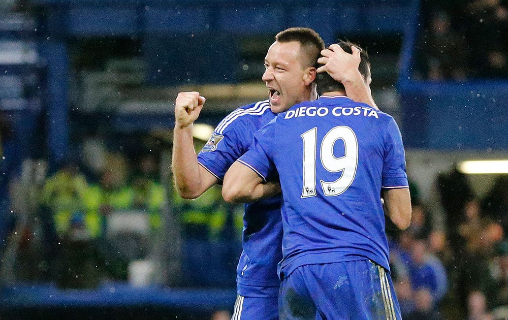 Chelsea's Diego Costa celebrates with John Terry after scoring a goal during the English Premier League soccer match between Chelsea and Manchester United at Stamford Bridge stadium in London.