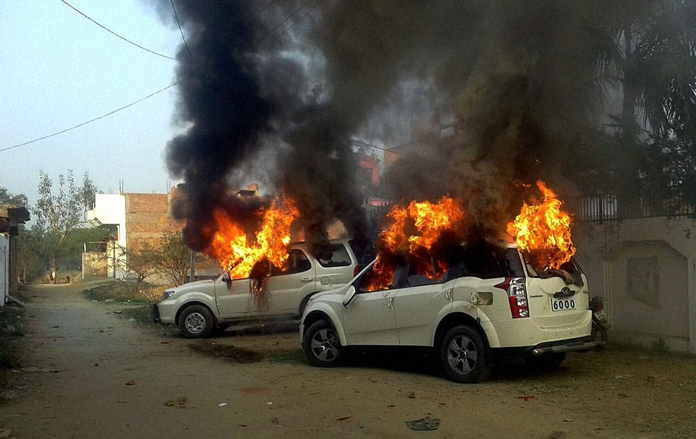 Angry villagers set ablaze vehicles of Samajwadi Party MLAs Prashant Singh and Saeed Ahmed after a clash between two group during UP Block pramukh polls voting in Bahadurpur village near,in Allahabad.