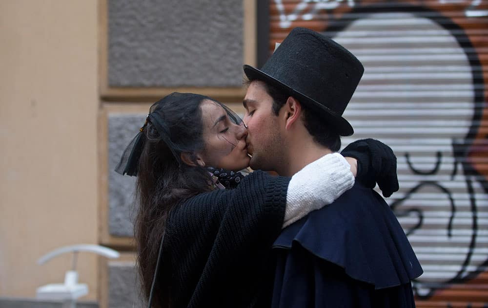 Members of the Alegre brotherhood kiss outside their headquarters in Madrid, Spain.