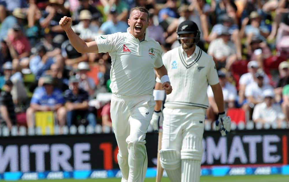 Australia’s Peter Siddle captures the wicket of New Zealand’s Henry Nichols for 8 on the first day of the first International Cricket Test match at Basin Reserve, Wellington, New Zealand.