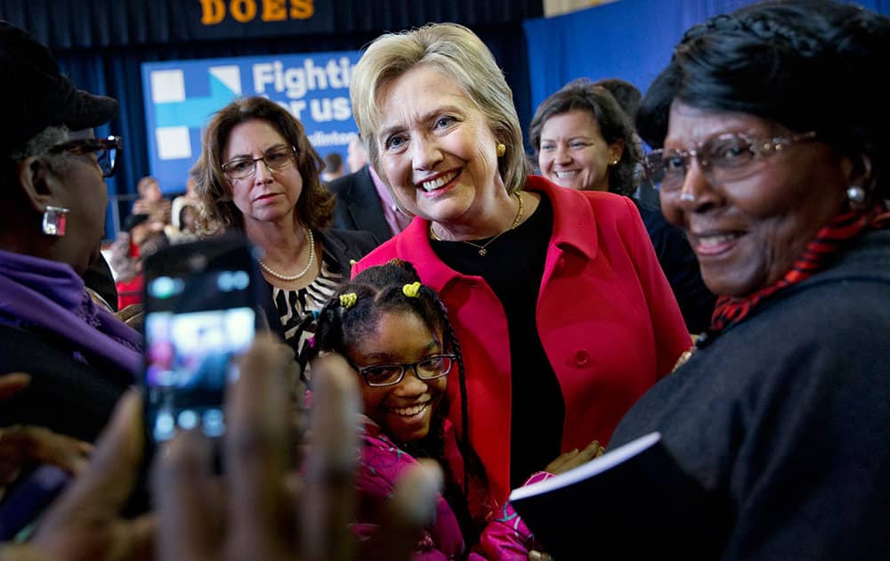 Democratic presidential candidate Hillary Clinton takes a photograph with Jordan Daniels, 11, of Denmark, S.C., during a town hall meeting at Denmark Olar Elementary School in Denmark.