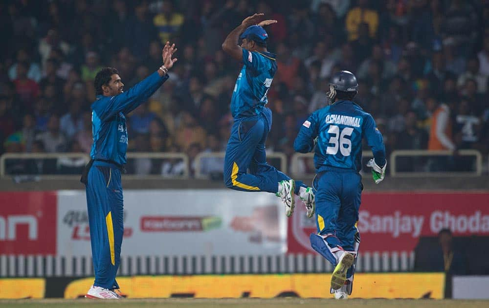 Sri Lankan players celebrate after claiming an Indian wicket during the second T20 match of a three match series between the two countries, in Ranchi.