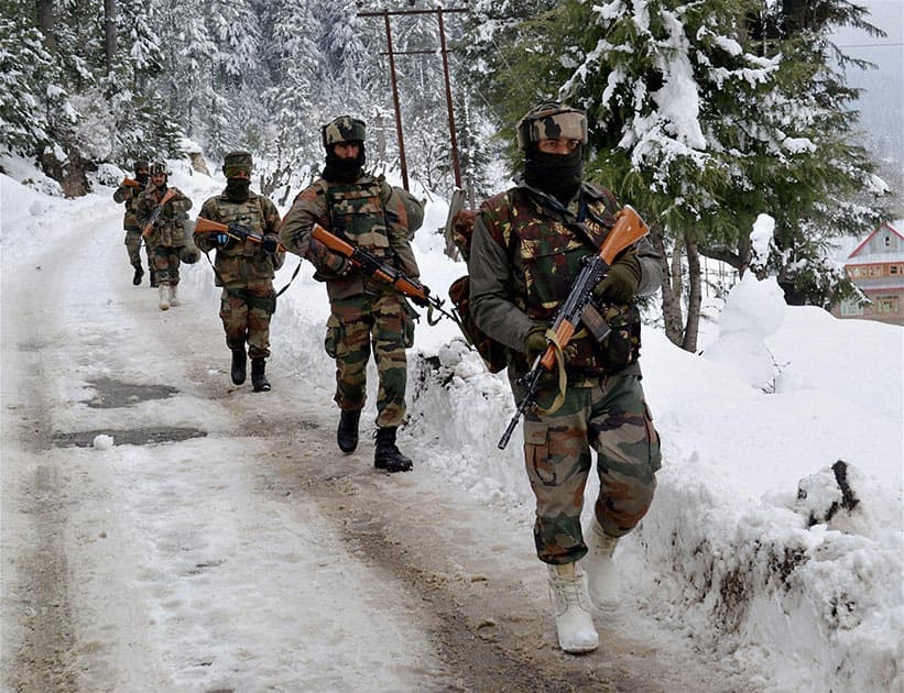 Army personnel move towards the house where militants were hiding during an encounter at Chowkibal in Kupwara district of North Kashmir.