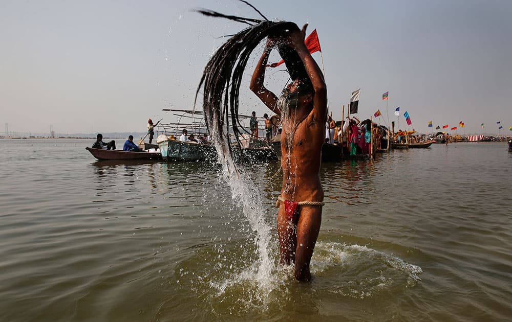 A Naga Sadhu, or Hindu holy naked man, takes holy dips at Sangam, confluence of Hindu holy rivers of Ganges, Yamuna and the mythical Saraswati, for a ritual dip, on the auspicious occasion of “Basant Panchami” at the annual traditional fair of Magh Mela in Allahabad.