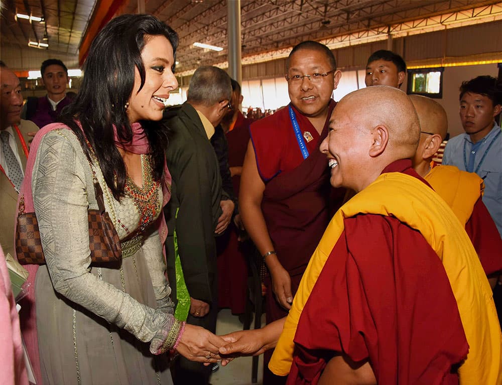 Actress Pooja Bedi a follower of 17th Karapa Ogyen Trinley Dorjee greets a nun at a programme to commemorate the life and enlightened activity of the Sixteenth Gyalwang Karmapa Rangjung Rigpe Dorje, in Bodhgaya.