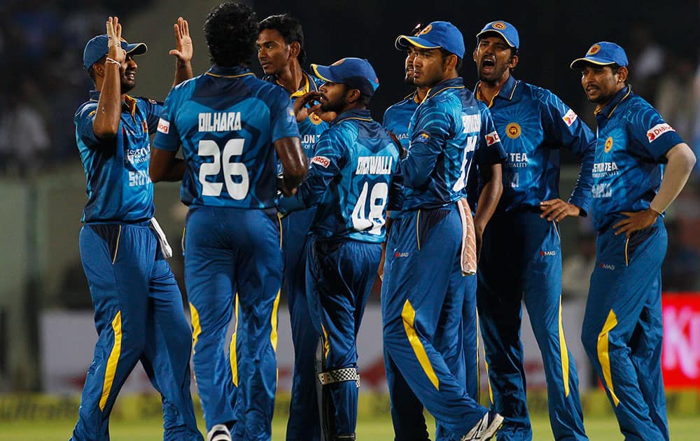 Sri Lankan players celebrate the dismissal of India's batsman Rohit Sharma during their third Twenty20 cricket match, in Vishakapatnam.