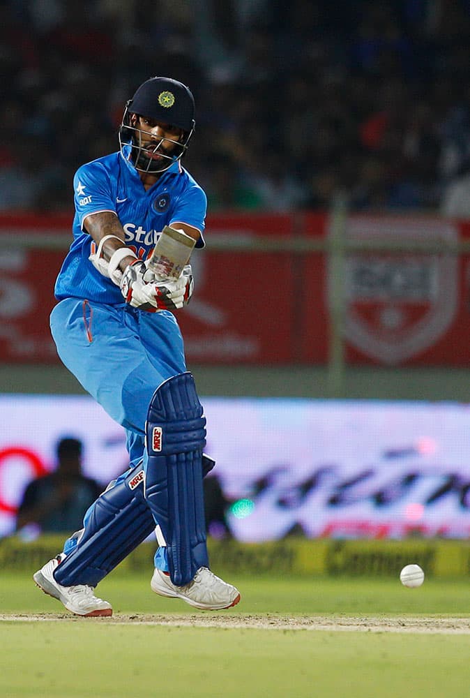 India's batsman Shikhar Dhawan plays a shot against Sri Lanka during their third Twenty20 cricket match, in Vishakapatnam.