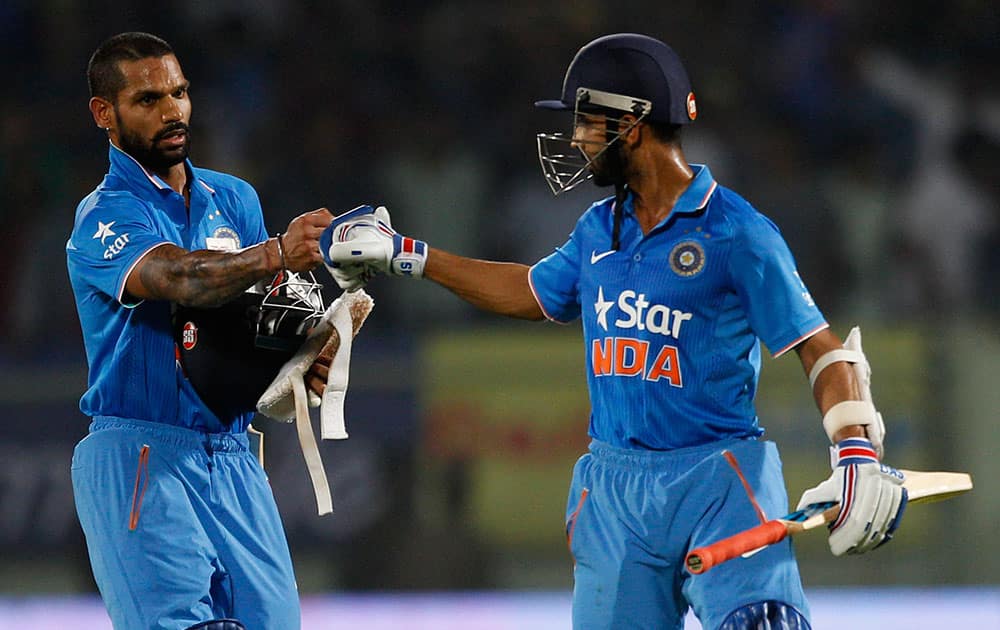 Indian cricketers Shikhar Dhawan, left, and Ajinkya Rahane greet each other to celebrate their victory against Sri Lanka in the third Twenty20 cricket match, in Vishakapatnam.