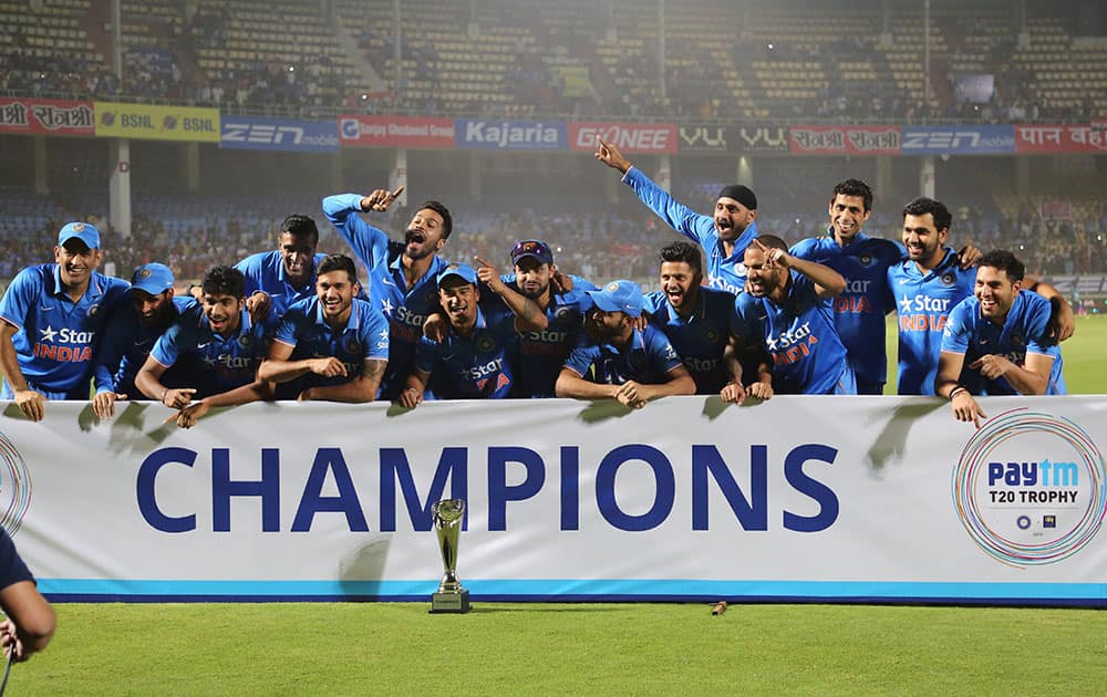 Members of the Indian cricket team celebrate with the winning trophy after their Twenty20 cricket series win against Sri Lanka, in Vishakapatnam.