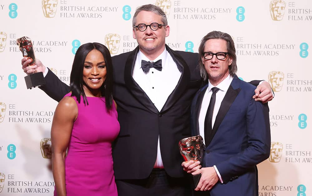 Actress Angela Bassett, left, with Adam McKay and Charles Randolph who hold their awards for Best Adapted Screenplay for the film 'The Big Short' backstage at the BAFTA 2016 film awards at the Royal Opera House in London.