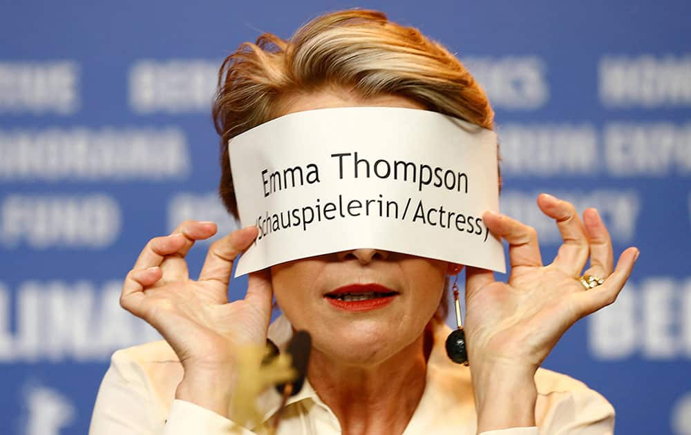 Actress Emma Thompson holds her name badge in front of her face during the press conference for the film Alone in Berlin at the 2016 Berlinale Film Festival in Berlin.