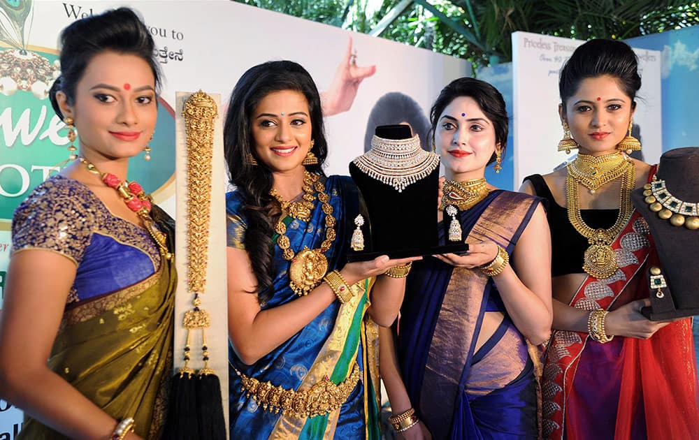 Actor Priyamani (2nd L) with models at a fashion show during Jewels Exotica in Bengaluru.