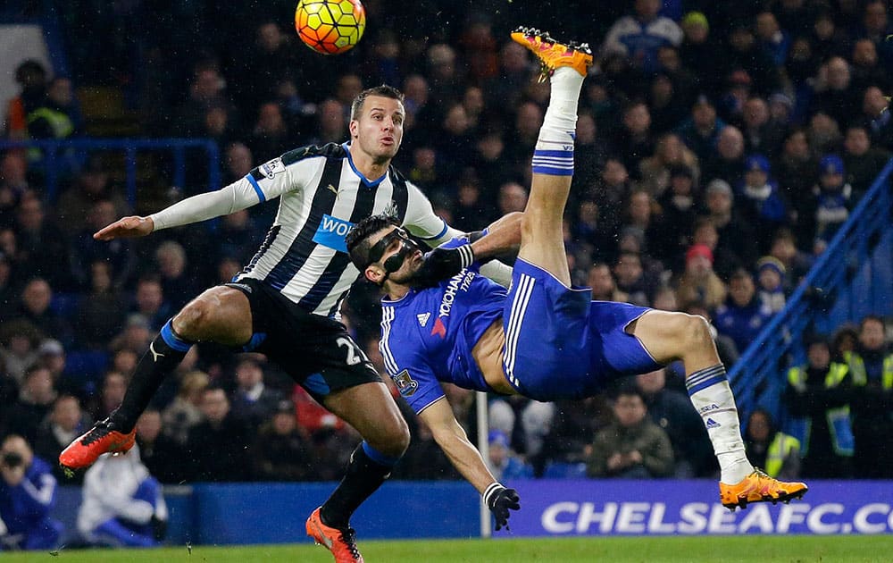Chelsea's Diego Costa tries to score an overhead kick past Newcastle United's Steven Taylor during the English Premier League soccer match between Chelsea and Newcastle United at Stamford Bridge stadium in London.