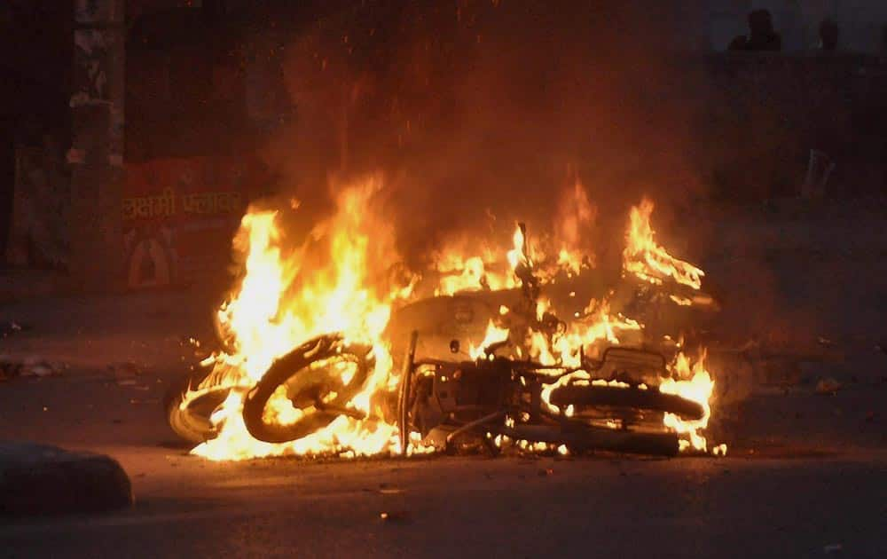 Jat community members torch motorcyles during their agitation for reservation in Rohtak.