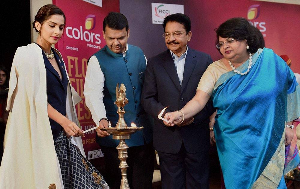 Actress Sonam Kapoor, Maharashtra Governor C Vidyasagar Rao, Chief Minister Devendra Fadnavis and FLO National President Archana Garodia lighting lamps during the inauguration of the FLO Film Festival in Mumbai.