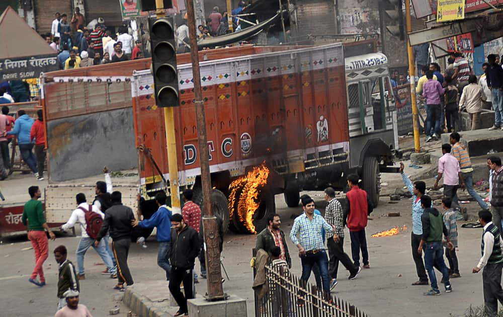 Protesters vandalize and damage vehicles during a pro caste quota protest in Rohtak. India's paramilitary forces shot and killed one person on Friday as protests for government benefits turned violent in northern India, police said. 