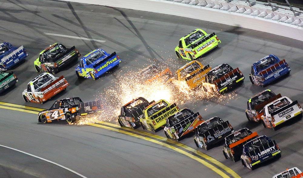 Christopher Bell (4) spins in front of a line of trucks in Turn 1 during the NASCAR Truck Series auto race at Daytona International Speedway in Daytona Beach, Fla.