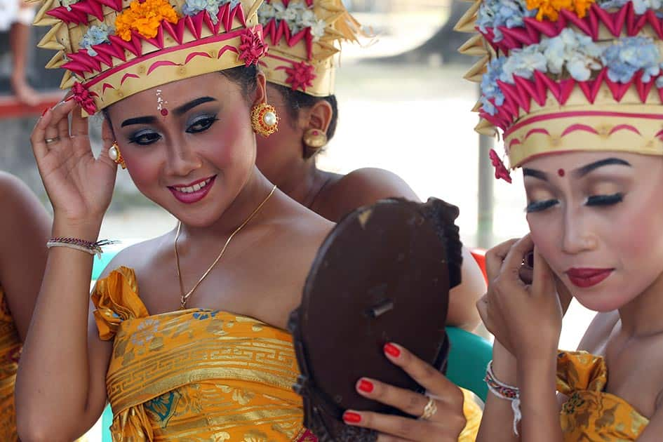 Balinese dancers prepare for their performance at Sakenan temple to celebrate the Kuningan festival in Bali, Indonesia.