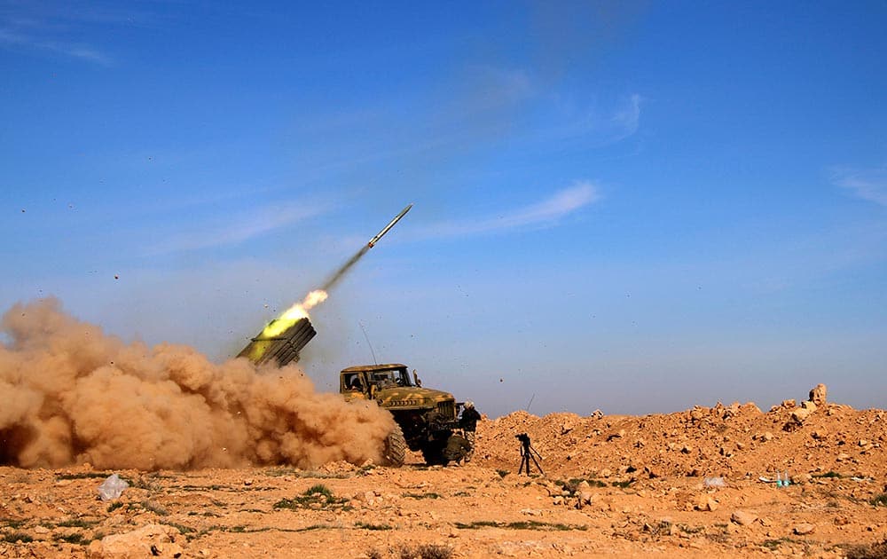 Soldiers from the Syrian army fire a rocket at Islamic State group positions in the province of Raqqa, Syria.