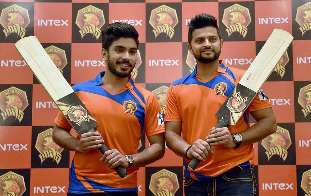 Gujarat Lions owner Keshav Bansal (L) and team captain Suresh Raina at the unveiling of the official team jersey for IPL Season 9 in New Delhi.