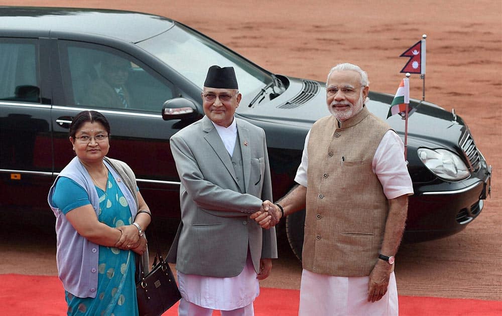 Prime Minister Narendra Modi greets his Nepalese counterpart Khadga Prasad Sharma Oli as his wife Radhika Shakya looks on during a ceremonial reception at Rashtrapati Bhavan in New Delhi.