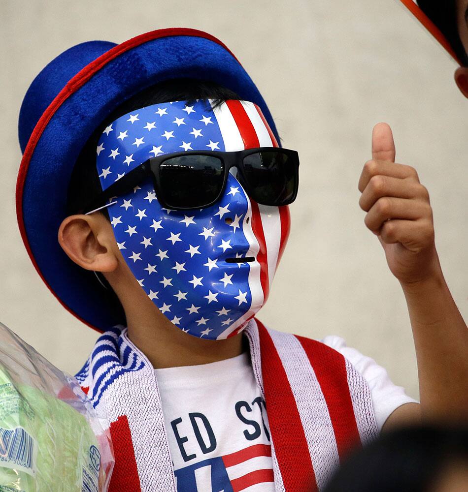 A United States fan watches as the team warms up before the CONCACAF Olympic women's soccer qualifying championship final against Canada.